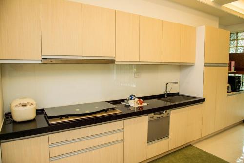 a kitchen with white cabinets and a counter top at Mountain Homestay 6-8人包棟民宿 in Xinhua