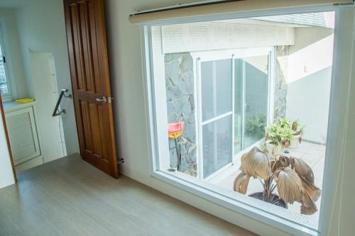 a window in a room with a stone wall at Mountain Homestay 6-8人包棟民宿 in Xinhua