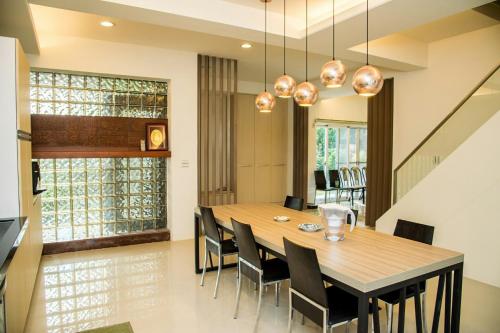 a dining room with a wooden table and chairs at Mountain Homestay 6-8人包棟民宿 in Xinhua