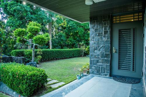 a front door of a house with a yard at Mountain Homestay 6-8人包棟民宿 in Xinhua