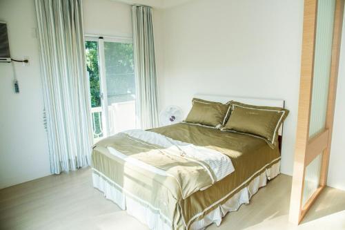 a bedroom with a bed and a large window at Mountain Homestay 6-8人包棟民宿 in Xinhua