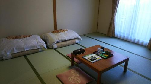Postel nebo postele na pokoji v ubytování Itoen Hotel Hakone Yumoto