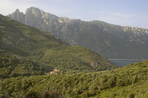 a view of a valley with mountains and a lake at Hotel Stella Marina in Serriera