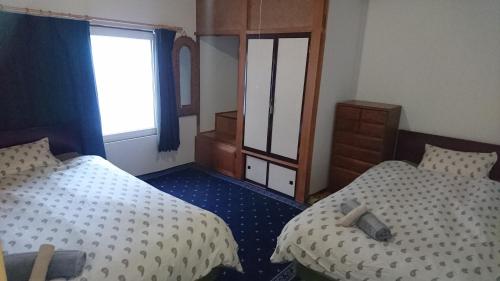 Ένα ή περισσότερα κρεβάτια σε δωμάτιο στο Yukiyama Chalet Apartments
