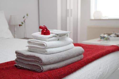 a stack of towels sitting on top of a bed at The Rooms Upstairs & Downstairs in Amsterdam