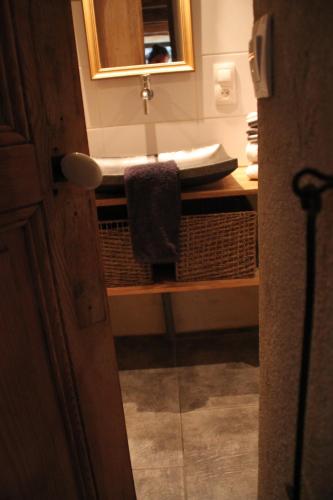 a bathroom with a sink and a counter with a mirror at La Demeure des Maitres in Chirols