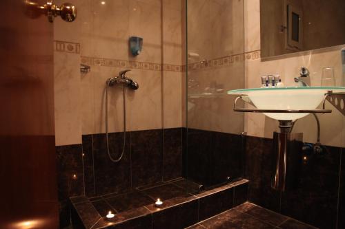 a bathroom with a shower and a sink at Anastazia Luxury Suites & Spa in Athens