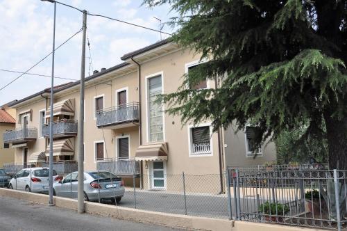 an apartment building with cars parked in front of it at GiaLoSa Biker House in Villa Verucchio