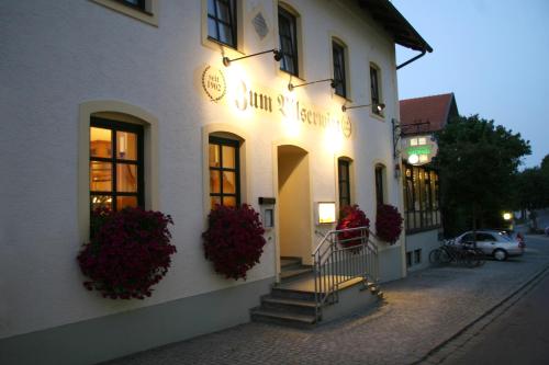 a white building with flowers on the side of it at Hotel - Landgasthof Obermaier Zum Vilserwirt in Altfraunhofen