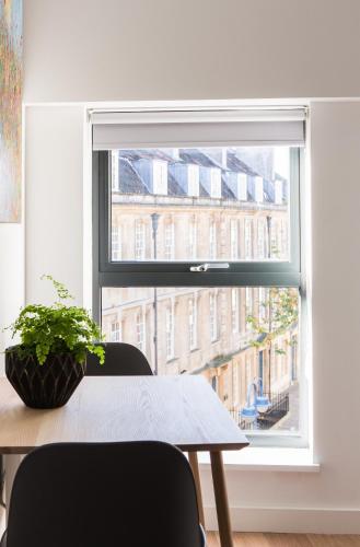 a window in a room with a table and chairs at Hiding Space Westgate Apartments in Bath