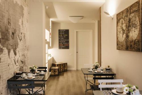 a dining room with two tables and chairs at Livingstone B&B in Matera