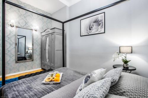 a bedroom with a bed with a tray of fruit on it at ClickTheFlat Palace Of Culture Apartment in Warsaw