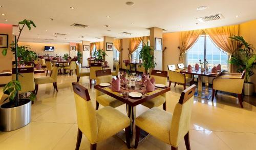 a dining room with a table and chairs at Coral Jubail Hotel in Al Jubail