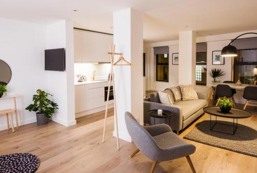 a living room with a couch and a table at Hiding Space Westgate Apartments in Bath