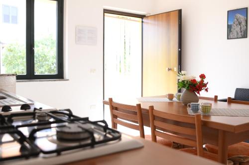 a kitchen with a stove top and a table at Le Zagare Case Vacanza in Cropani