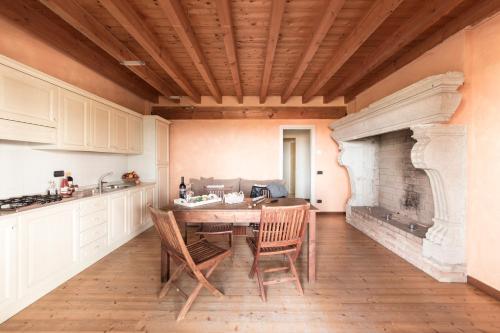 a kitchen with a table and chairs and a fireplace at Agriturismo Podere L'Agave in San Vincenzo