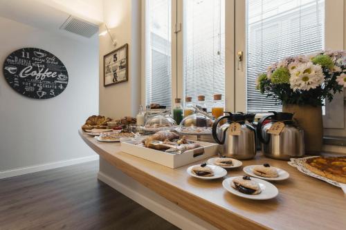 a table with a buffet of pastries and food at Livingstone B&B in Matera