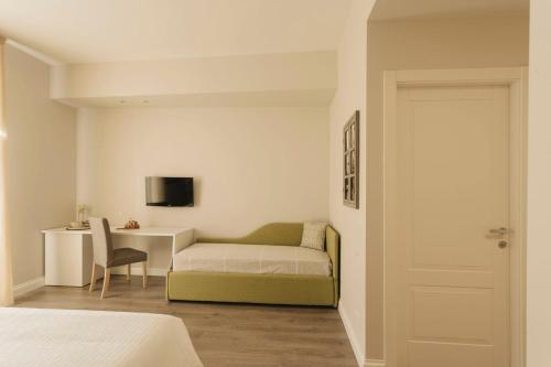 a small bedroom with a bed and a desk at Livingstone B&B in Matera