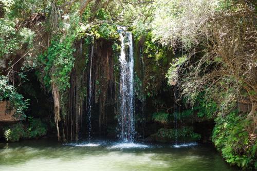 a waterfall in the middle of a body of water at Blyde Canyon, A Forever Resort in Matibidi