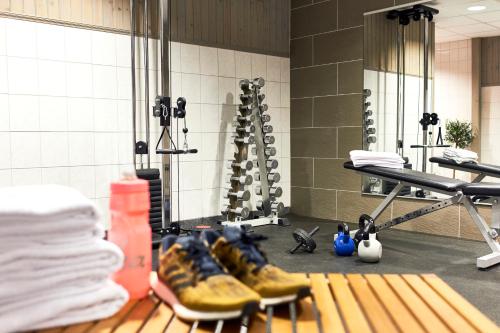 a bathroom with a bunch of shoes and a shower at Home Hotel Temperance in Malmö