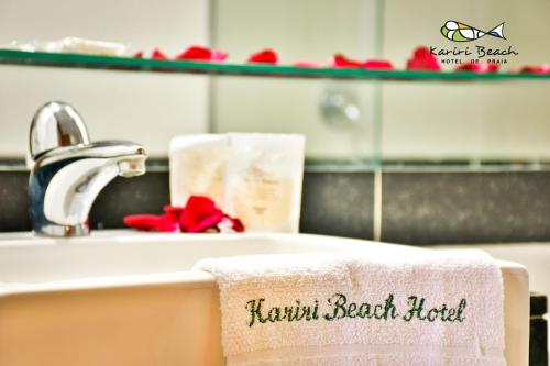 a bathroom sink with a towel that reads farewell beach hotel at Kariri Beach Hotel in Cumbuco