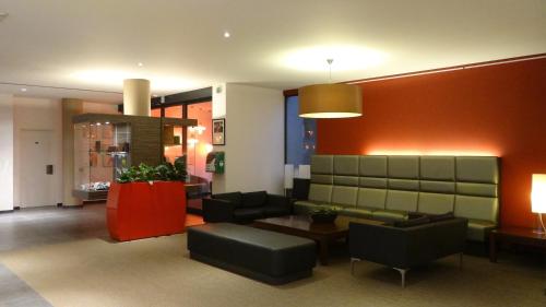 a living room with a couch and a table at ibis Antwerpen Centrum in Antwerp