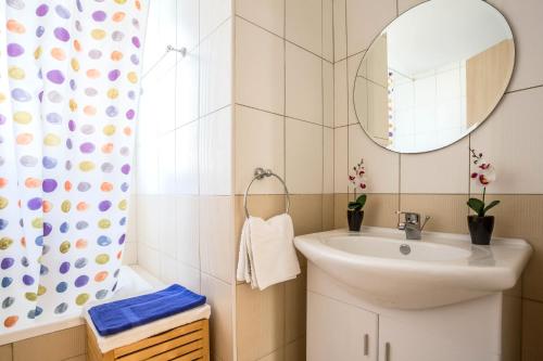 a bathroom with a sink and a mirror at Villa Costas in Protaras