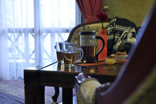 a wooden table with two glasses of beer on it at Arthotel Mini-Hotel in Bukovel