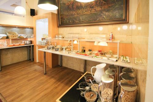 a kitchen with a sink and a counter top at Hotel Sachsenhof in Berlin