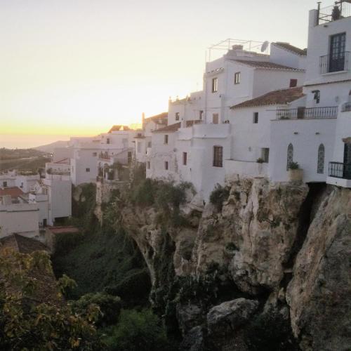 a group of white buildings on a cliff at Hotel y Bungalows Balcón de Competa in Cómpeta