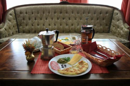 a table with a plate of pizza on it at Arthotel Mini-Hotel in Bukovel