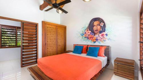 a bedroom with a bed with a painting on the wall at Private Holiday House in Tangangge