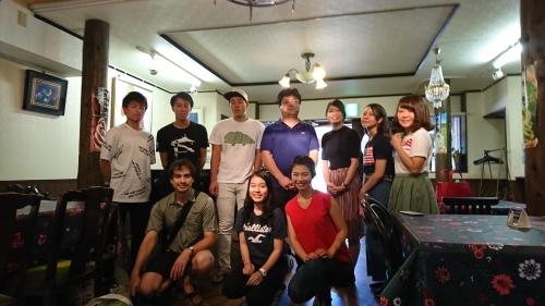a group of people posing for a picture in a room at Live Cafe Hisui no Umi in Itoigawa