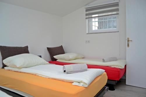 two beds sitting next to each other in a room at Apartmani Balibeg in Sarajevo