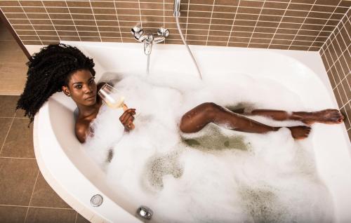 a woman laying in a bath tub filled with foam at Penzion U Výra in Výrovice