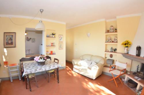 a living room with a table and a couch at La Cipressa in Collodi