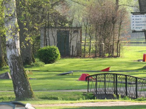 a park with a bench in the grass at Hotel De Watermolen in Bocholt