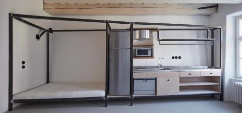 a room with a bunk bed with a sink at Stajnhaus in Mikulov