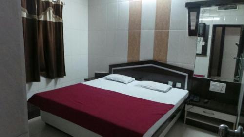 a bedroom with a bed and a sink and a mirror at Hotel Raj Palace in Ajmer