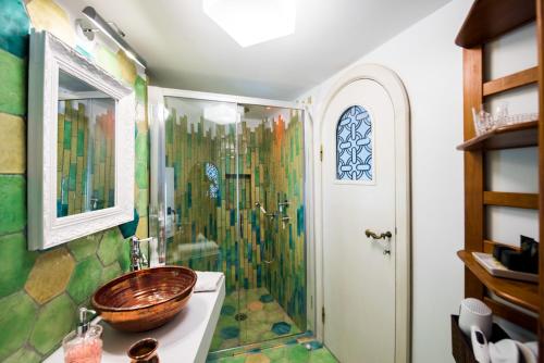 a bathroom with a shower with a sink and a toilet at Villa Torre Trasita luxury suites in Positano
