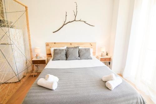 a bedroom with a bed with two white towels on it at P&P Apartament Lagunillas I y II in Málaga