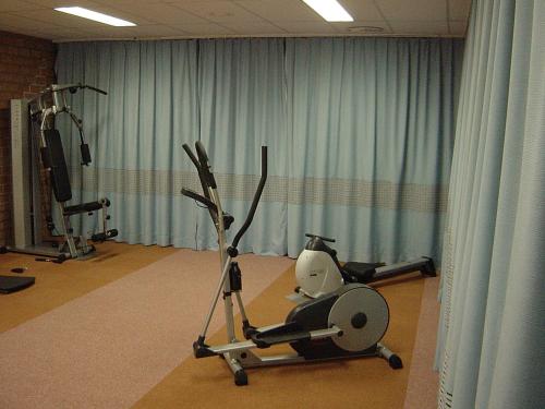 a room with a gym with a exercise bike at Hotel De Watermolen in Bocholt