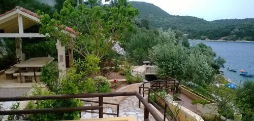 a balcony of a house with a view of a lake at Levantes Houses in Vathi, Ithaka