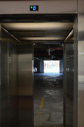 an elevator in a parking garage with a clock on it at Hotel Bahamas in Montevideo
