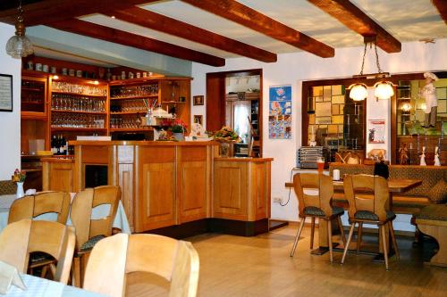 a restaurant with a bar and a table and chairs at Baunhöller-Mühle in Emmelshausen