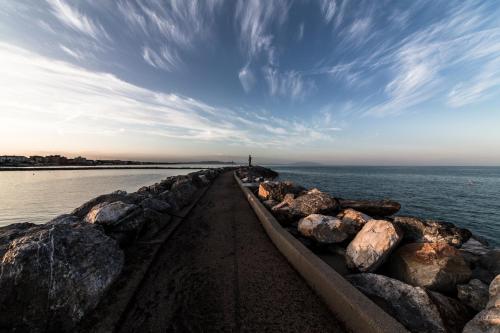 a row of rocks next to the water at Residenza Santa Cecilia in San Vincenzo