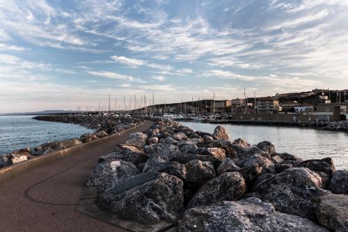 a group of rocks in the water near a harbor at Residenza Santa Cecilia in San Vincenzo