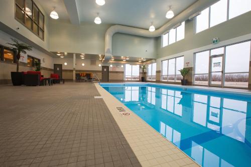 a large swimming pool in a large building at Best Western Plus Airport Inn & Suites in Saskatoon