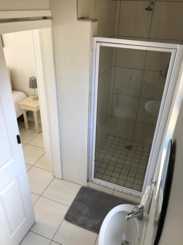 a bathroom with a shower and a sink at 10 on Beresford in East London