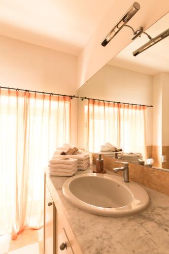 a bathroom with a sink and a large mirror at Residenza Santa Cecilia in San Vincenzo